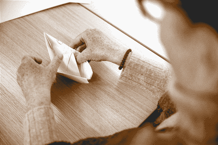 A close up of an origami boat made by a participant