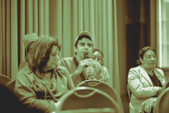 An audience member asking a question to the panel